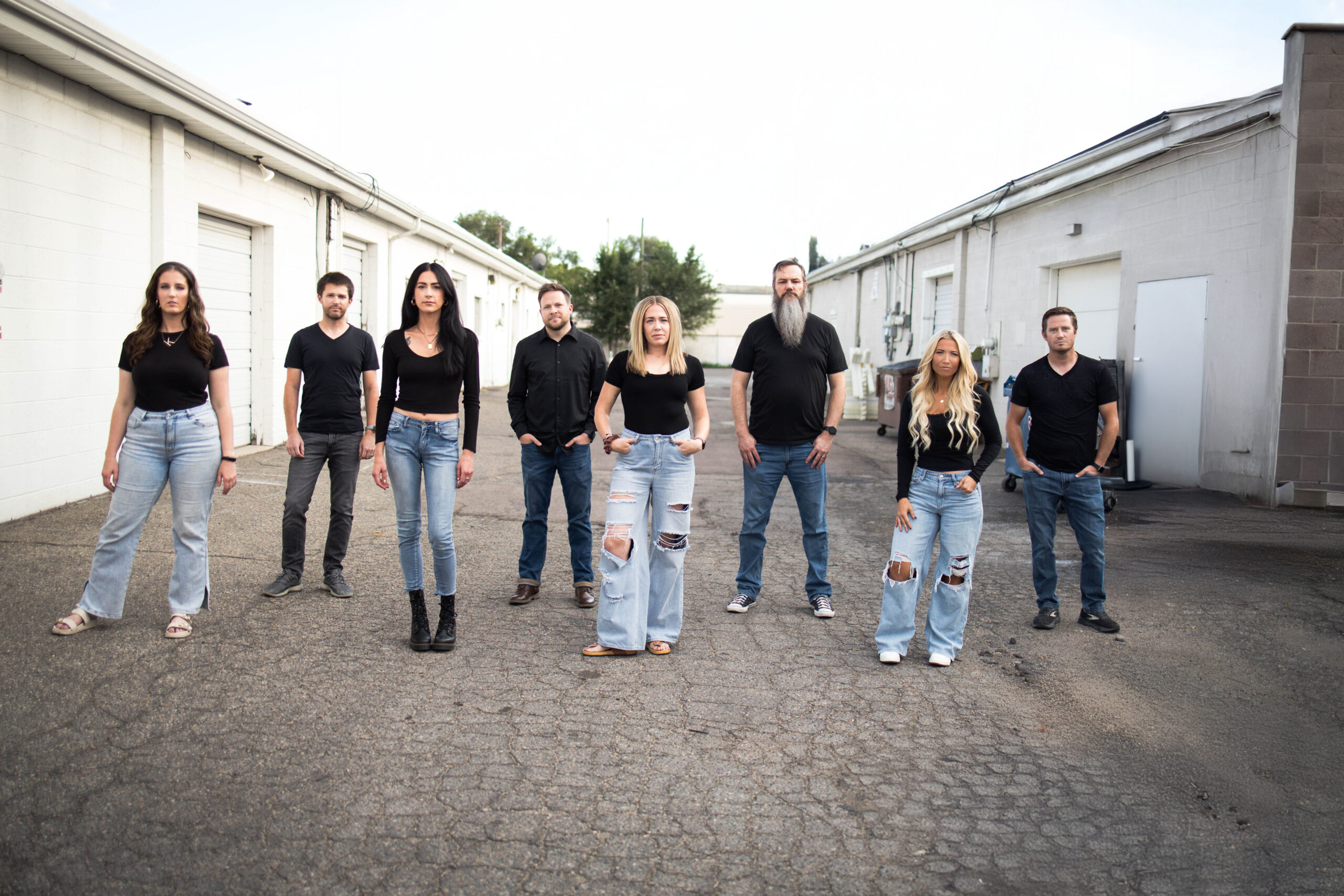 VoxSola Acapella Group, 4 guys, 4 girls, all wearing jeans and black shirts in an alleyway